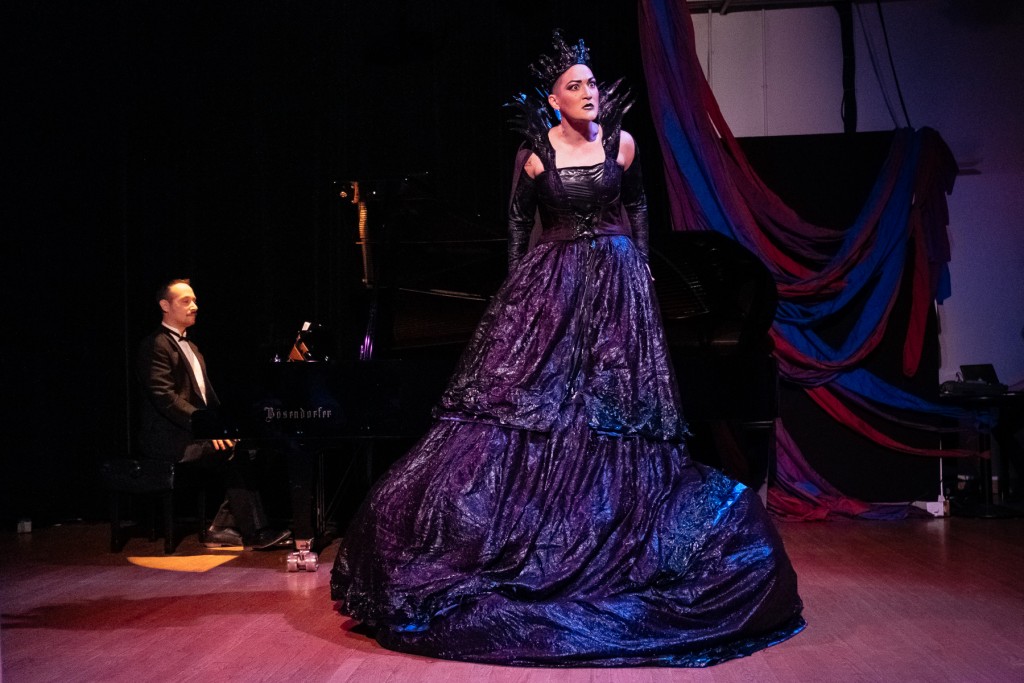 Teiya sings in a dramatic dark ballgown